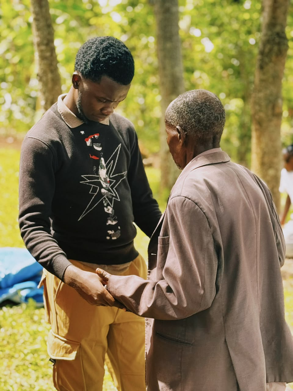 Prophet Abbey praying with an elder